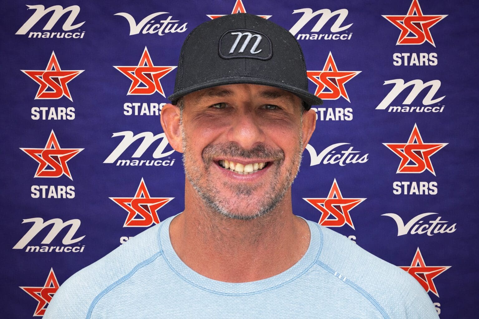 Smiling man in front of logos